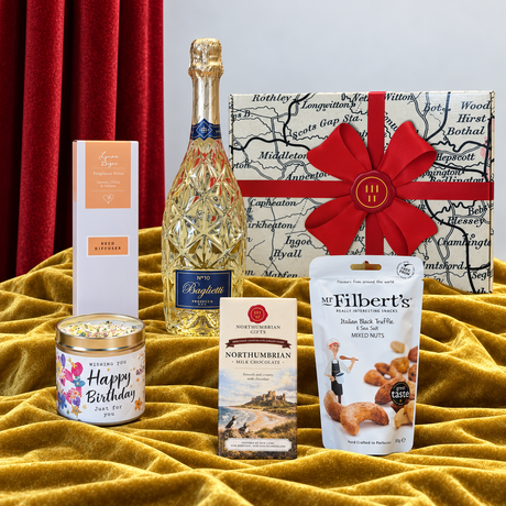 Northumbrian Happy Birthday hamper with Prosecco, milk chocolate, mixed nuts, birthday candle, reed diffuser and gift box.